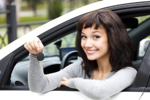 Pretty girl showing the car key